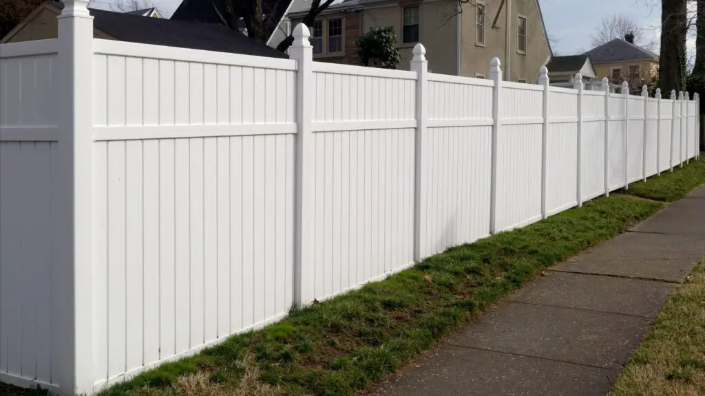Here's a fabulous white vinyl fence along the home acting like a privacy fence with very little space in between slats